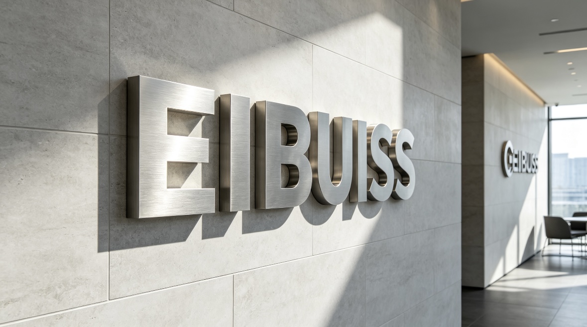 Unlit stainless‑steel signage real corporate lobby application Non‑illuminated brushed stainless‑steel logo letters mounted on corporate office reception brand wall